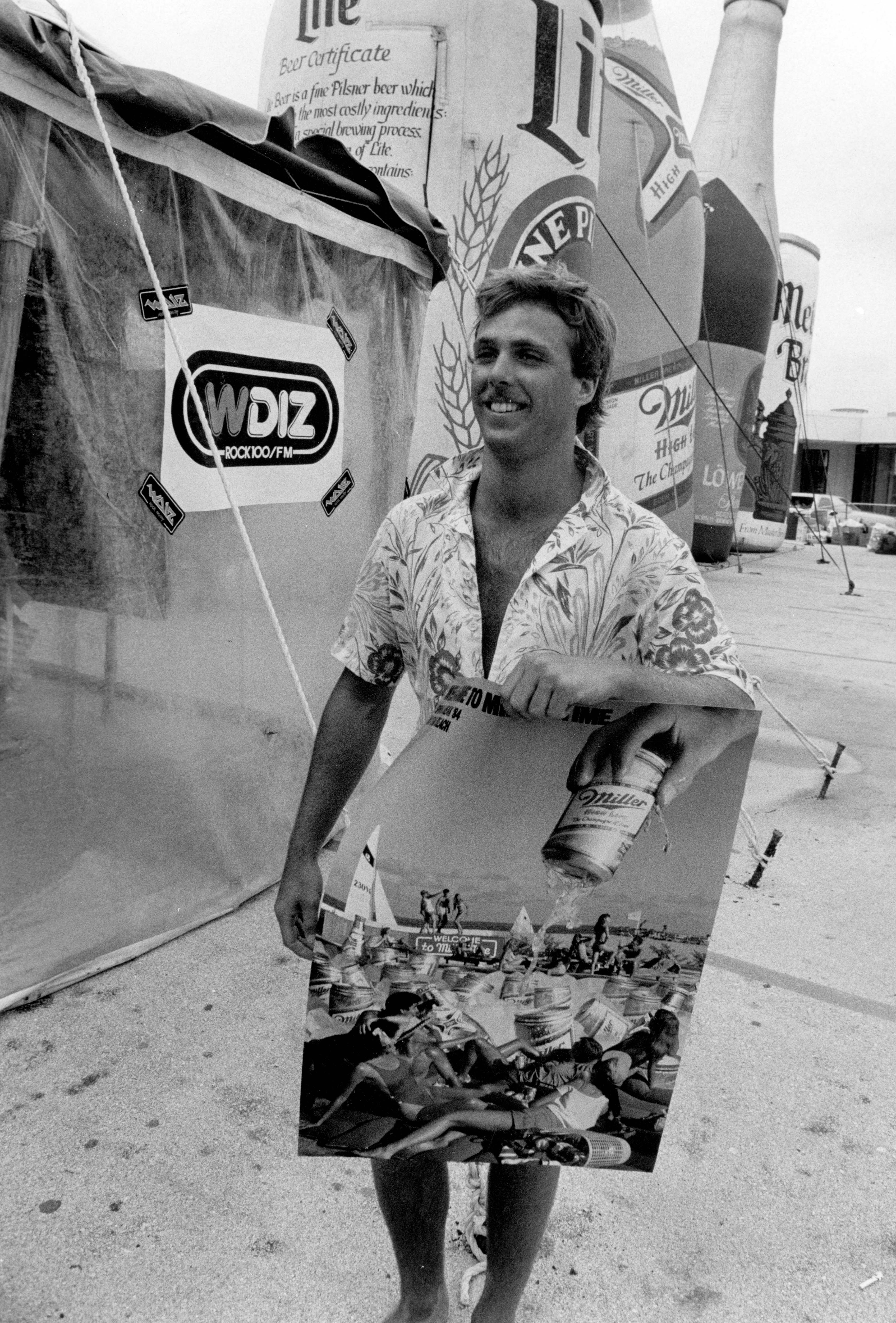 John Hucke, from Long Island, NY, gets a poster at...