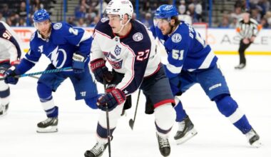 Columbus Blue Jackets center Sean Monahan (2) splits between Lightning center Brayden Point (21) and defenseman Charle-Edouard D'Astous (51) during the third period of Columbus' 5-2 win Tuesday night in Tampa, Fla. (Chris O'Meara/Associated Press)