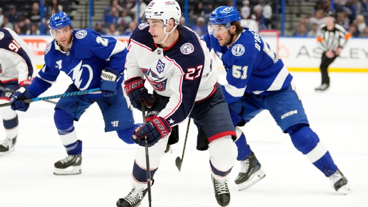 Columbus Blue Jackets center Sean Monahan (2) splits between Lightning center Brayden Point (21) and defenseman Charle-Edouard D'Astous (51) during the third period of Columbus' 5-2 win Tuesday night in Tampa, Fla. (Chris O'Meara/Associated Press)