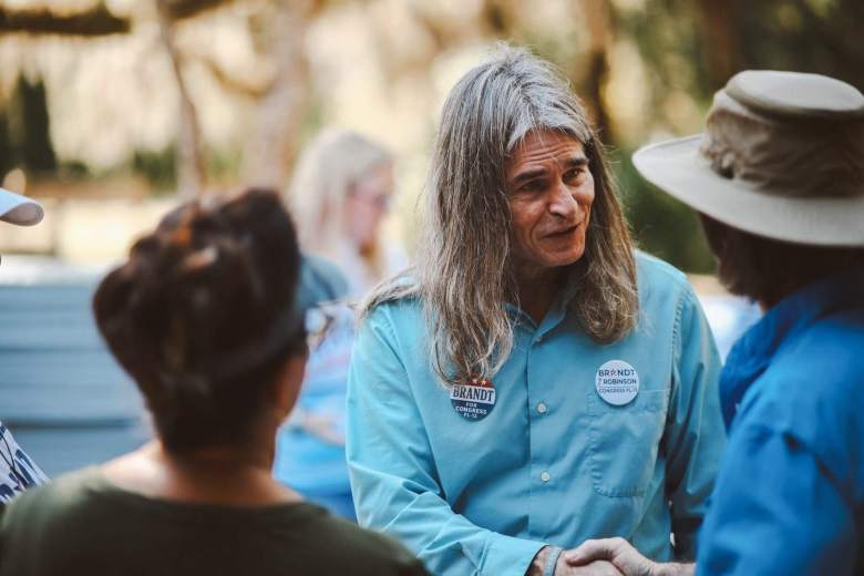 Brandt Robinson, a Pinellas County teacher and 2026 Democratic candidate for Florida's 13th Congressional District, shaking hands with a supporter at a campaign kickoff event.