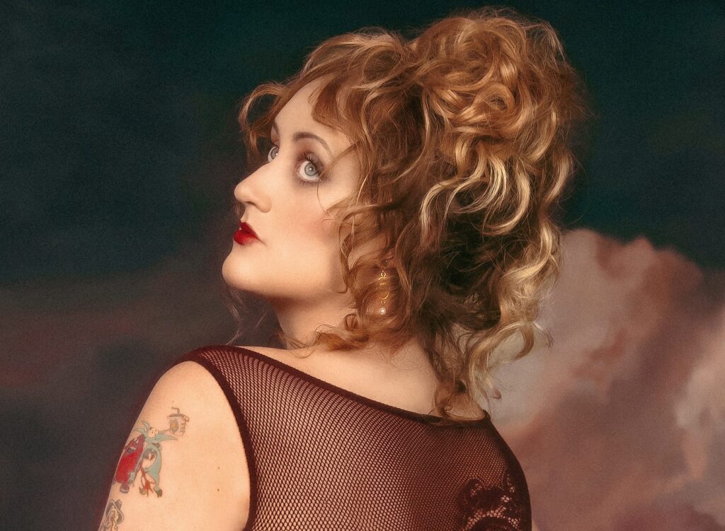 The cover art for Brittany Broski's single 'The Sun,' featuring a classical-style portrait of her looking upwards against a cloudy backdrop