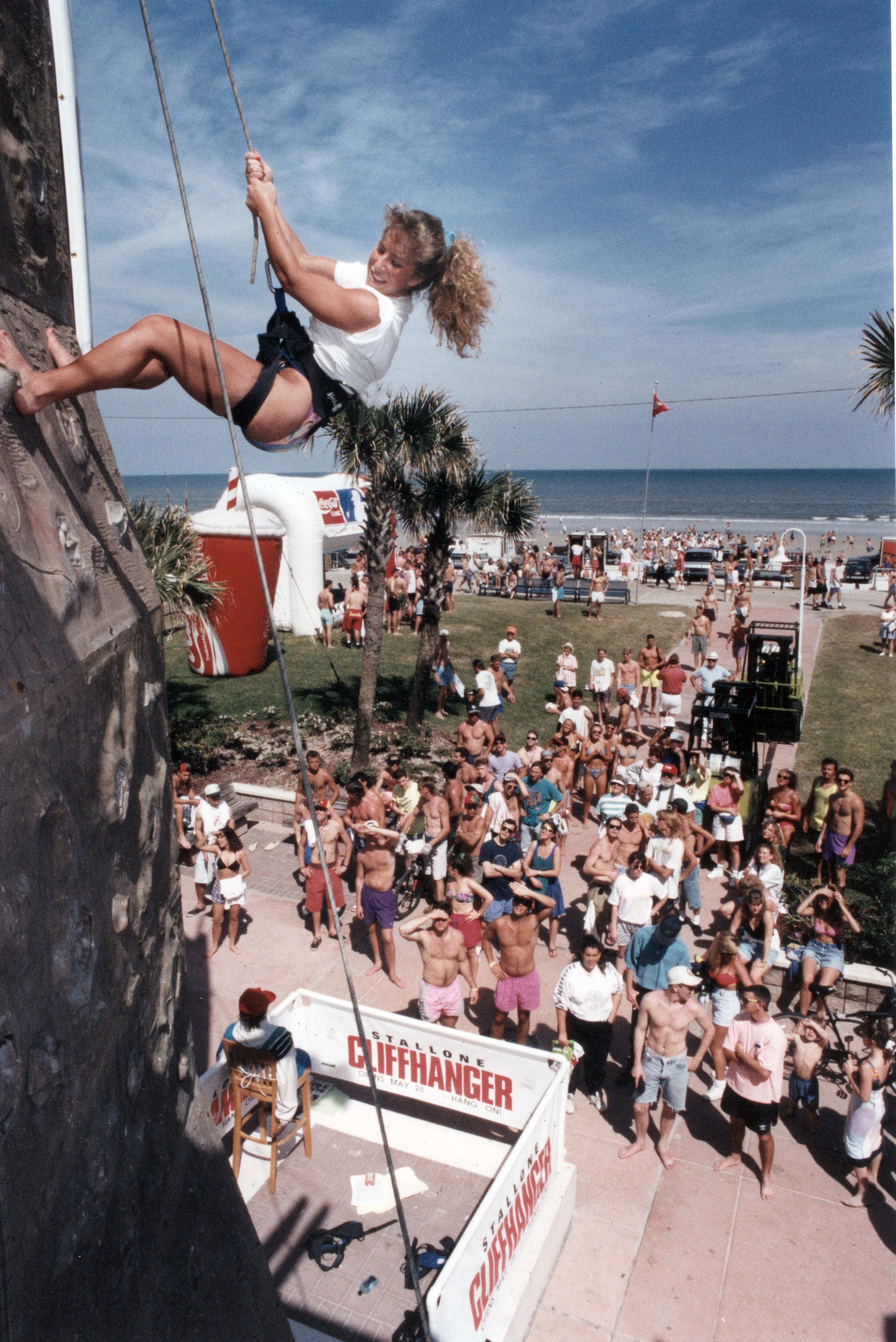 An unidentified woman climbs a rock wall at the 