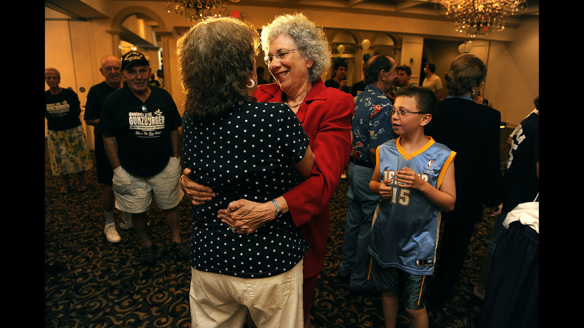 Sue Gunzburger, right, receives a hug from one of her...