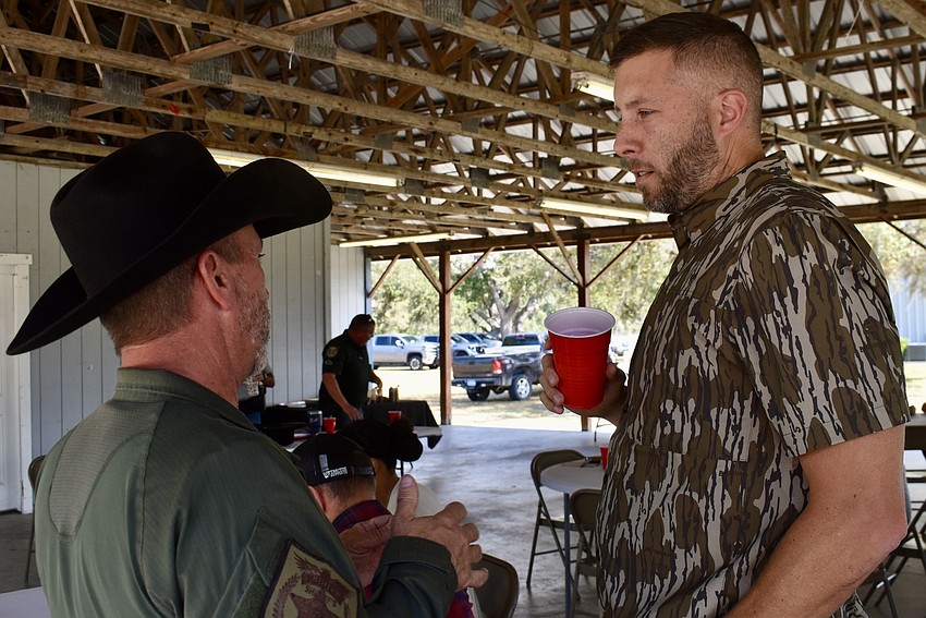 Myakka City's Sergeant Rob Hendrickson shares his experience with animal abuse cases with Orlando's Sergeant Neal Chase following February's meeting of the Florida Agricultural Crimes Intelligence Unit.