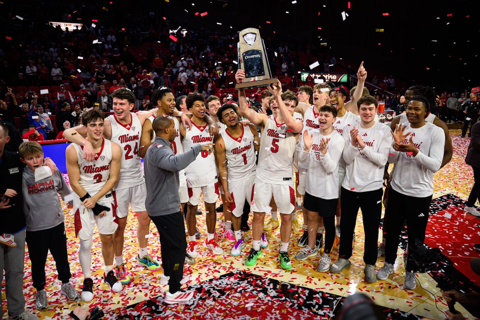 The Miami University men's basketball team hoists the Mid-American Conference trophy after beating Toledo 74-72 on Tuesday, March 3, 2026 at Millett Hall. JEREMY MILLER / CONTRIBUTED PHOTO
