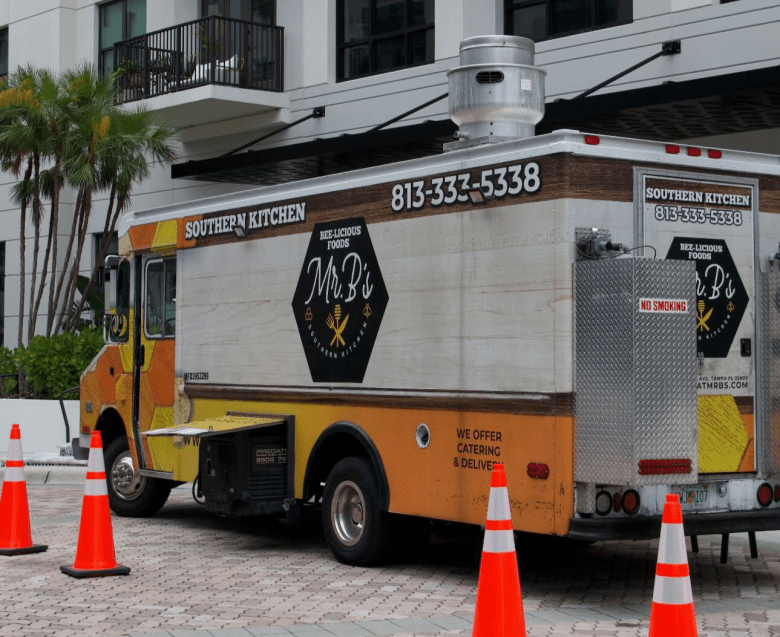 Mr. B's Southern Cuisine food truck parked in Tampa, featuring its signature black and yellow "Rollin' with Flavor" branding.