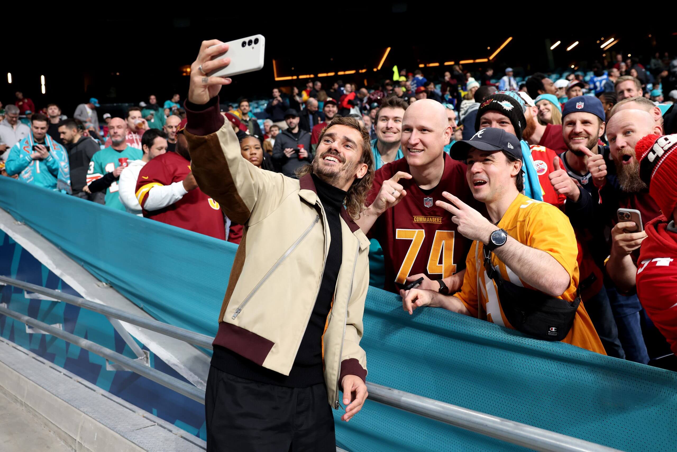Griezmann takes a selife with fans at the Bernabeu before the NFL 2025 game between Washington Commanders and Miami Dolphins 