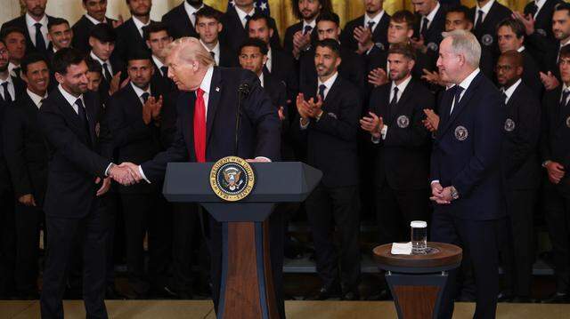 WASHINGTON, DC - MARCH 05: (L-R) Lionel Messi of Inter Miami CF shakes hands with U.S. President Donald Trump as Inter Miami CF CEO and Managing Owner Jorge Mas looks on during an event celebrating the 2025 MLS Cup Champions Inter Miami CF in the East Room of the White House on March 05, 2026 in Washington, DC. Inter Miami defeated the Vancouver Whitecaps 3-1 to win their first MLS Cup championship. (Photo by Win McNamee/Getty Images)