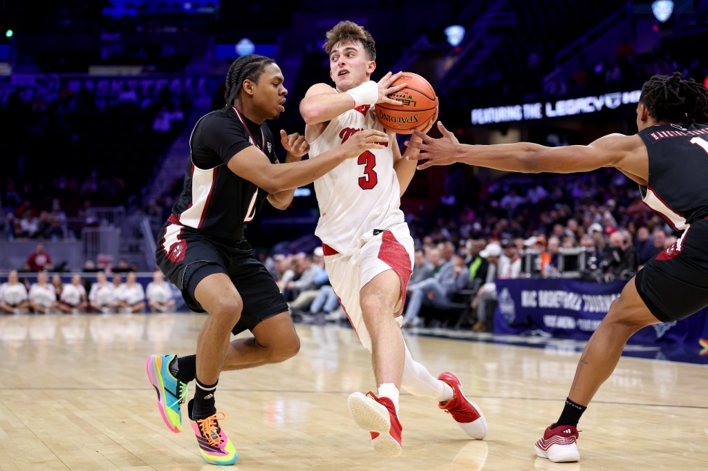 Miami (OH) RedHawks guard Luke Skaljac (3) drives to the basket as UMass Minutemen guard Danny Carbuccia (0) defends during the MAC quarterfinals on March 12, 2026.