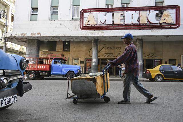 A recyclable materials collector pushes a cart in front of the America Theater in Havana on March 13, 2026. Cuba's President Miguel Diaz-Canel confirmed on March 13, 2026 that "Cuban officials have recently held talks" with representatives of the United States, amid heightened tensions between Washington and Havana. 
