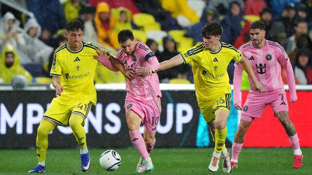 NASHVILLE, TENNESSEE - MARCH 11: Lionel Messi #10 of Inter Miami CF is challenged by Warren Madrigal #41 and Matthew Corcoran #16 of Nashville SC during the CONCACAF Champions Cup 2026 match between Nashville SC and Inter Miami CF at GEODIS Park on March 11, 2026 in Nashville, Tennessee.  (Photo by Chris Carter/Getty Images)