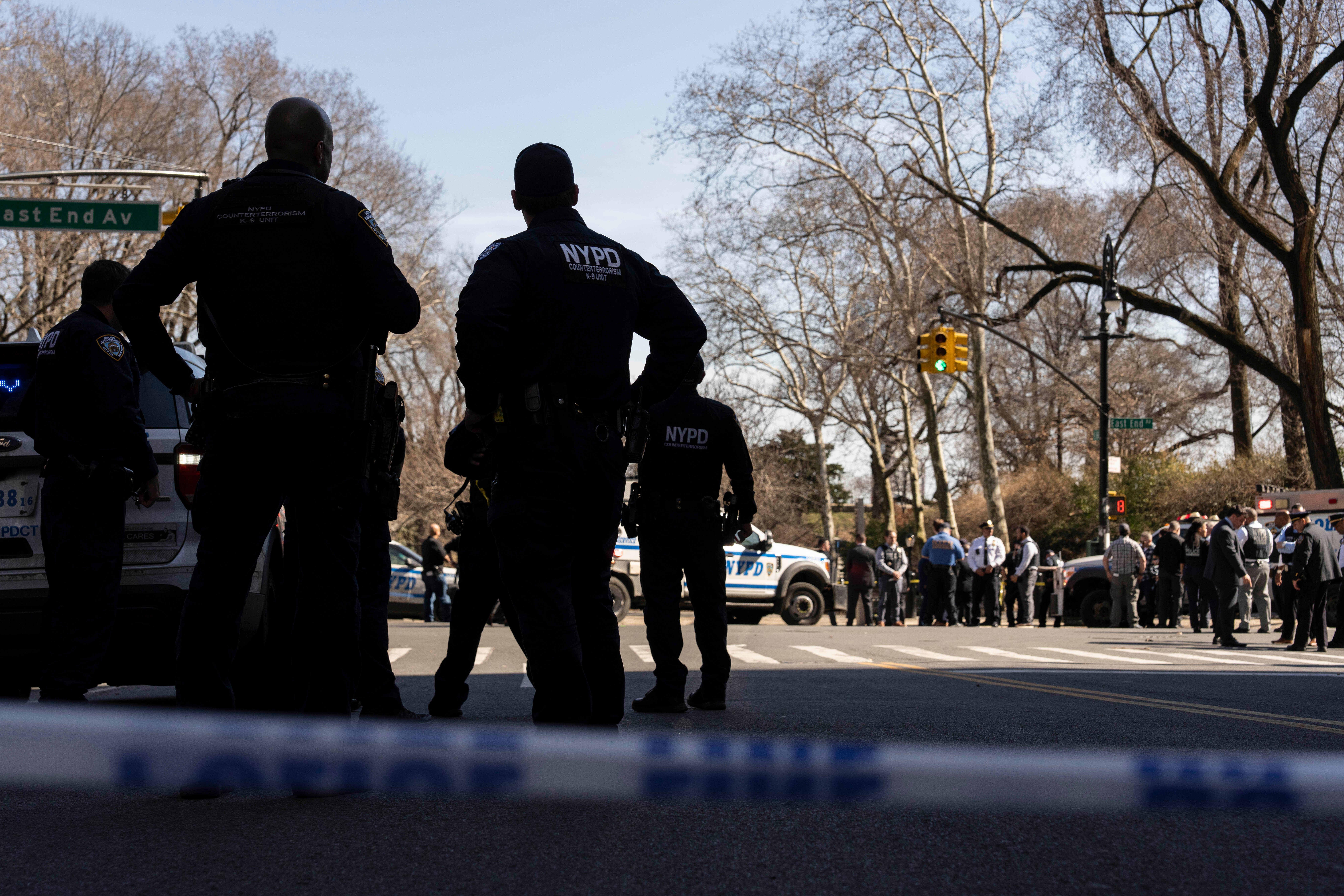 NYPD officers stand outside Carl Schurz Park as they investigate...