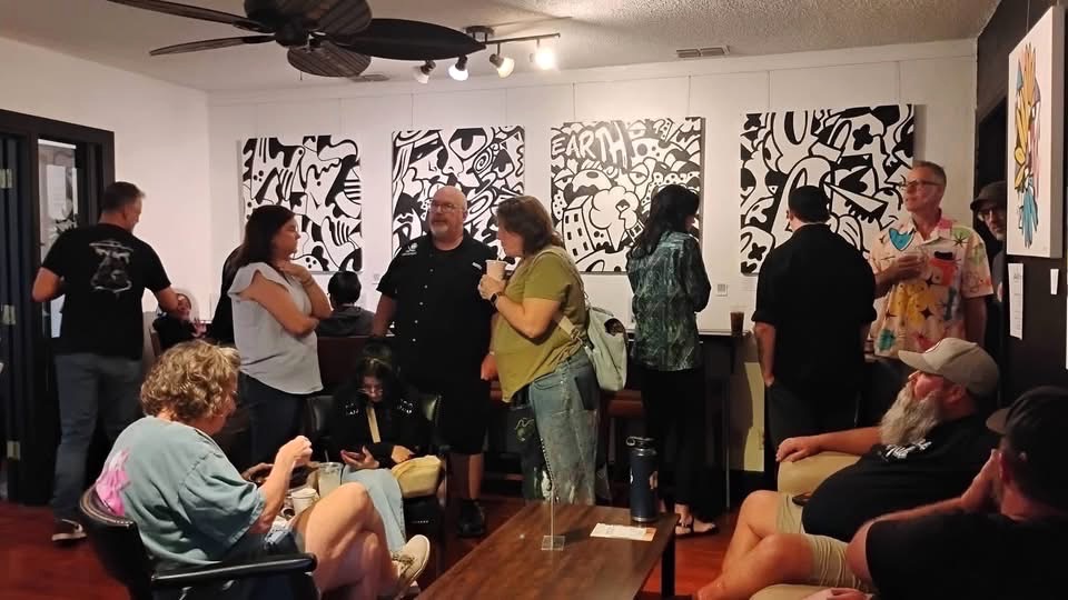 Guests enjoy Alfredo Barranco's artwork.