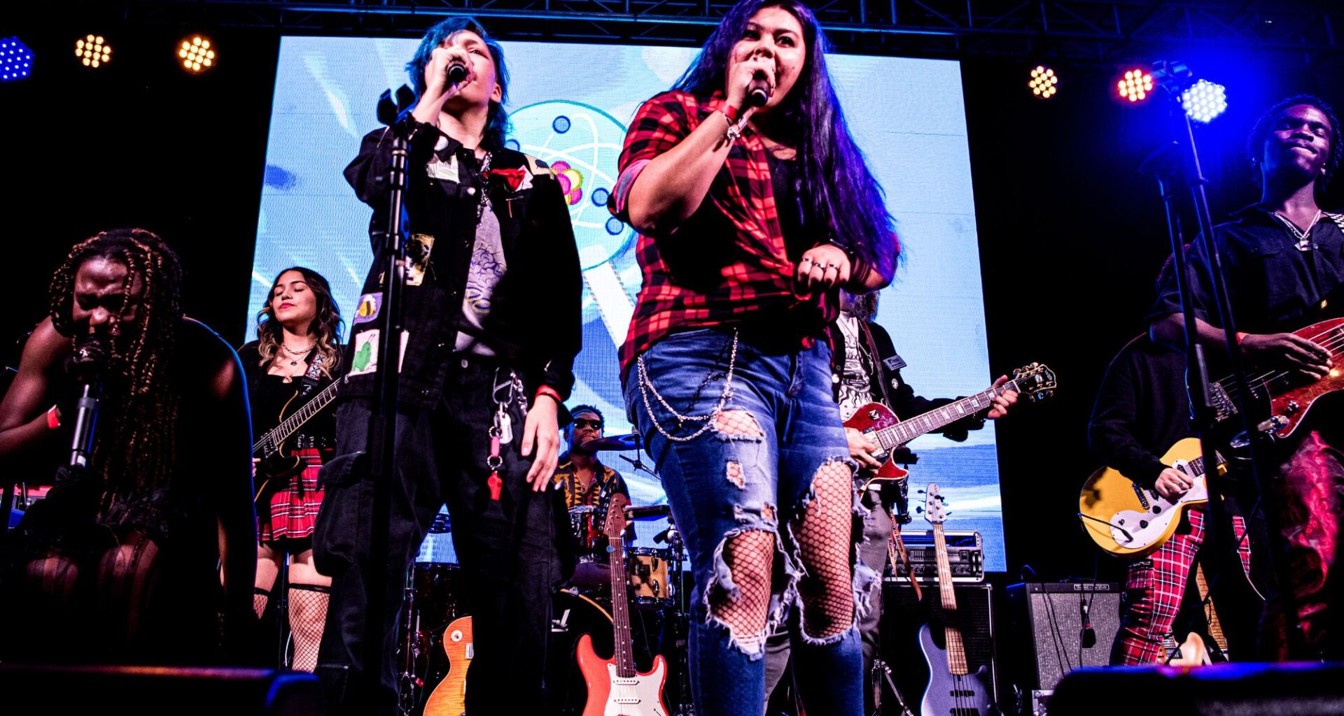 Photo of a group of young musicians on stage singing in Miami