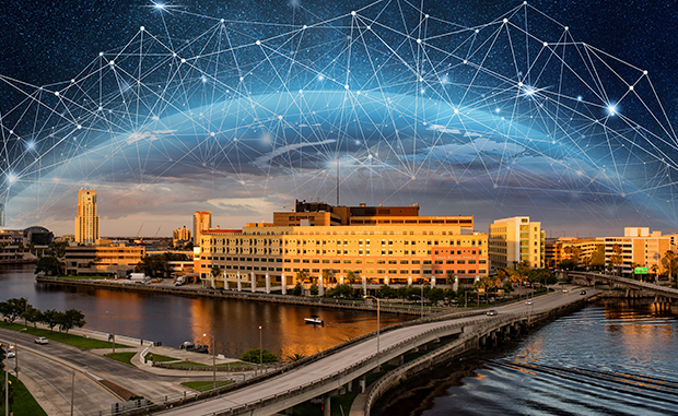 How Tampa General Hospital Accelerates AI Adoption. Tampa General Hospital under an AI web bubble.