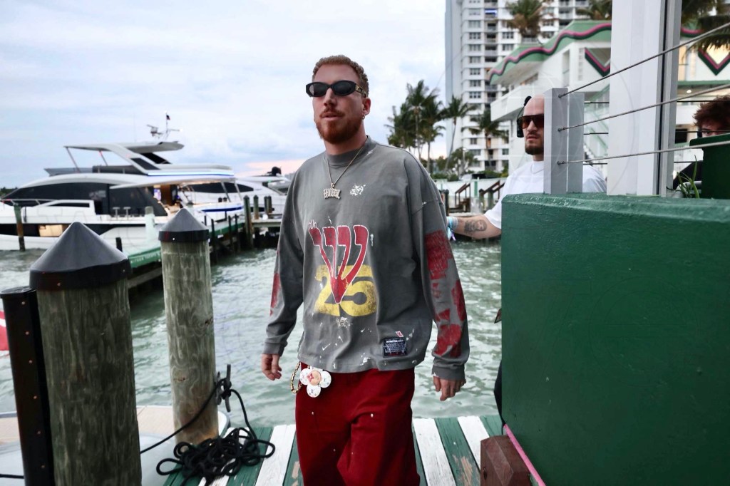 photo of DJ Hugel walking on a deck in a marina