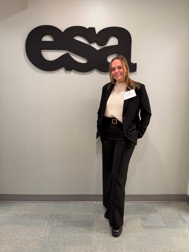 Lillie Bradshaw stands in front of an ESA sign