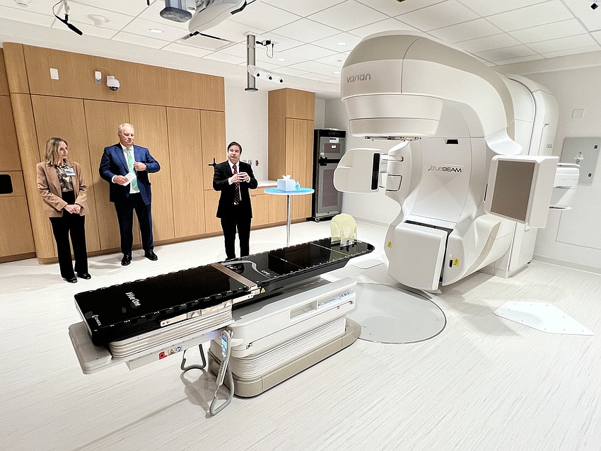 During a June 10 media tour of The Duan Family Building at the Mayo Clinic in Florida, radiation oncologist Dr. Laura Vallow, Dr. Kent Thielen, CEO of Mayo Clinic in Florida, and radiation oncology researcher Chris Beltran show one of the three photon therapy units available to treat cancer patients beginning July 7.
