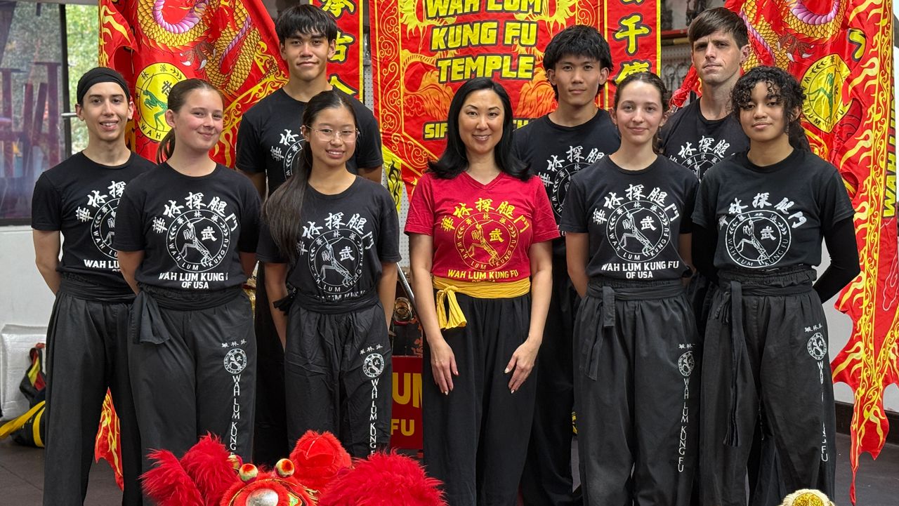 Sifu Mimi Chan (center) poses with her students inside the Wah Lum Kung Fu Temple in Orlando. (Spectrum News/Emma Delamo)