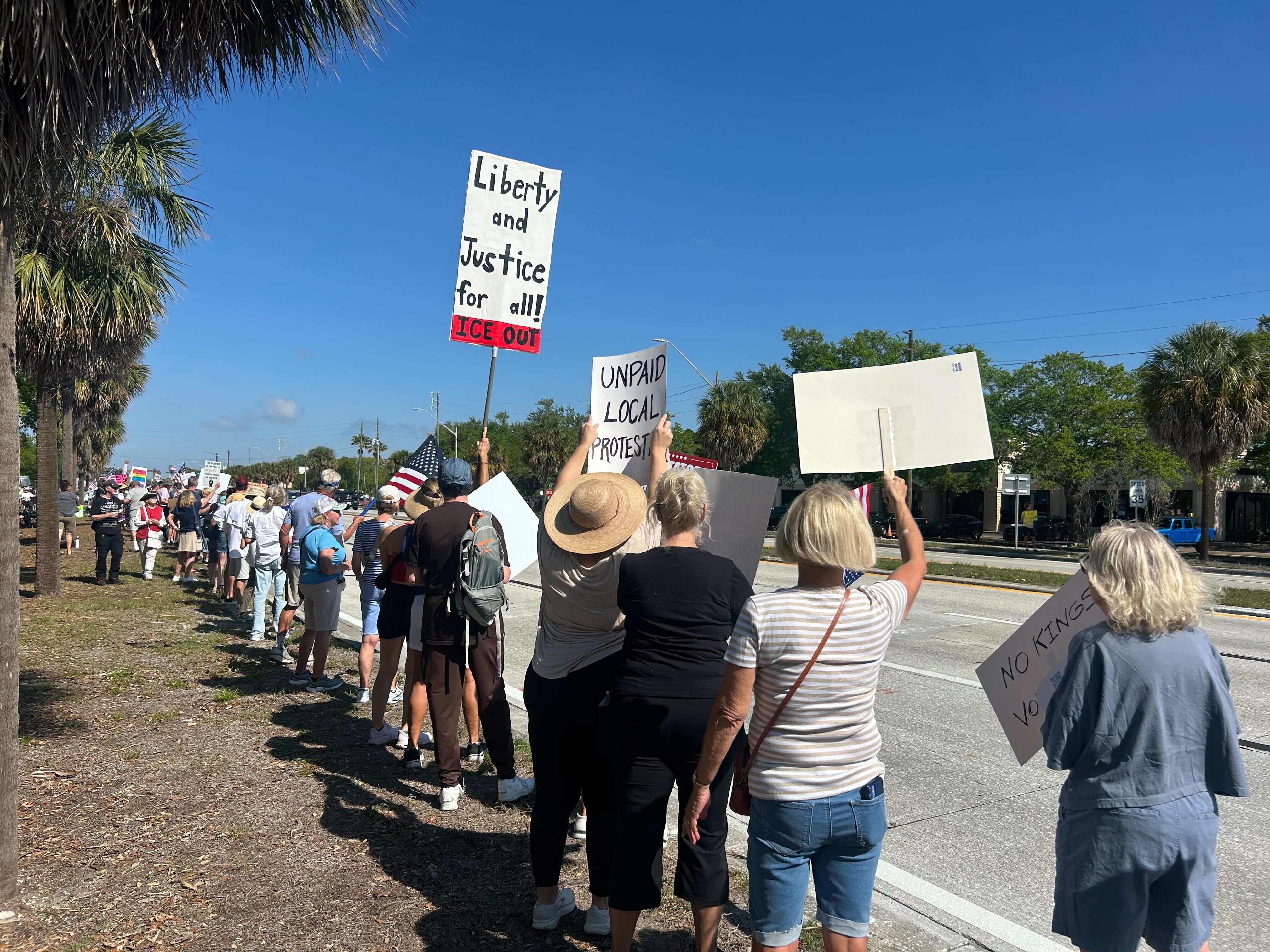Protestors line street.
