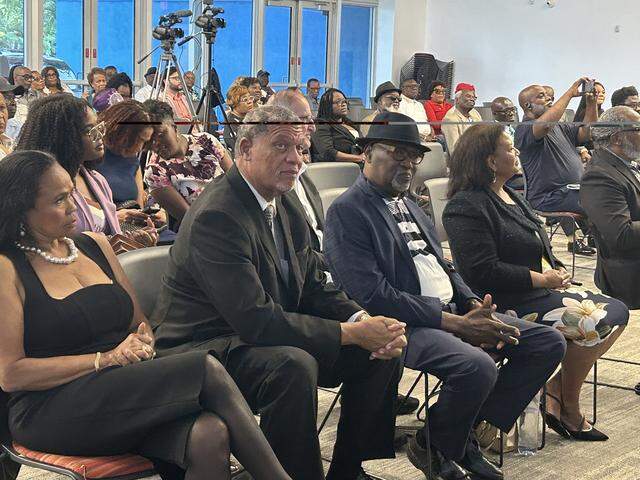 From left to right: Activist Farah Juste, Rev. Richard Dunn and former North Miami Councilman Jacques Despinosse join others in celebrating the legacy of the late Rev. Jesse Jackson on Saturday, March 21, 2026, at the Gerard Jean-Juste Community Center in Oak Grove.