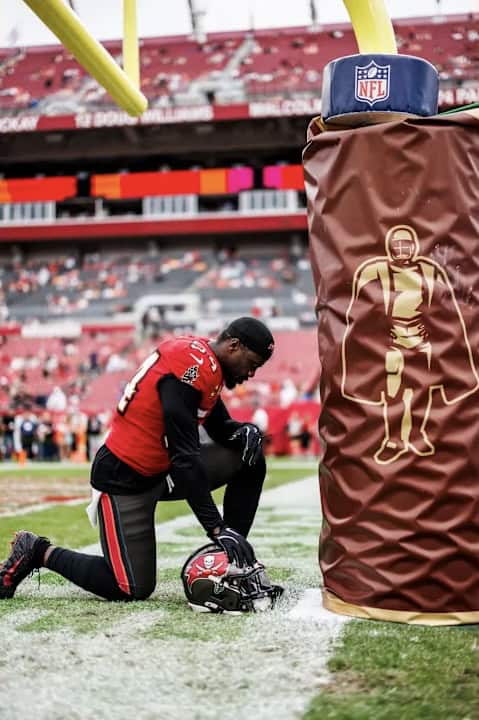 Football player praying before a game