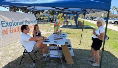 Student interns John Carreiro and Summer Sorensen, who are part of Eckerd College's Gulf Scholars program, speak with a resident as part of a push to get input to see what kind of beach resilience projects the public supports. (Spectrum News/Tyler O'Neill)