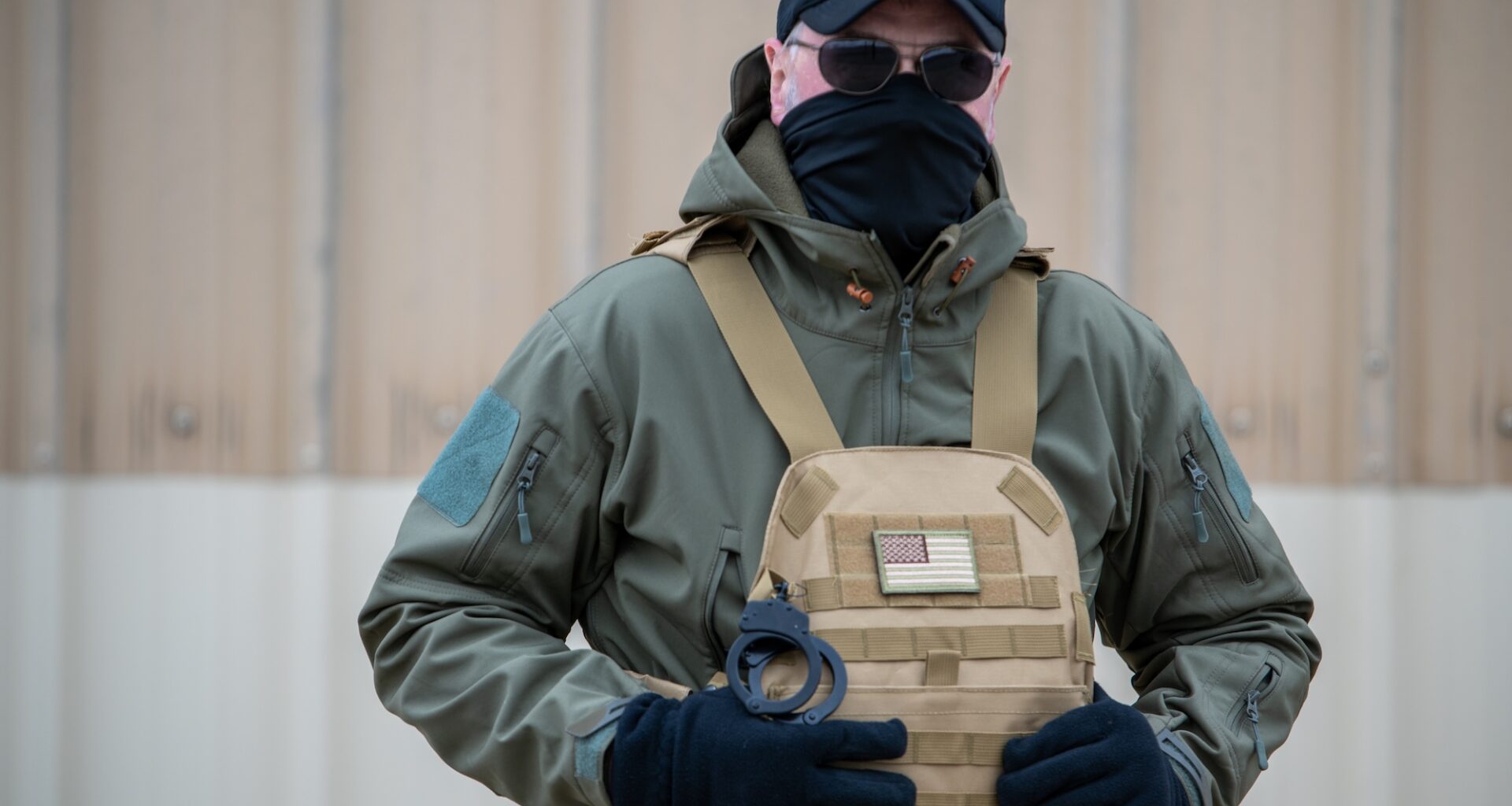 photo of an ICE agent in a mask and uniform