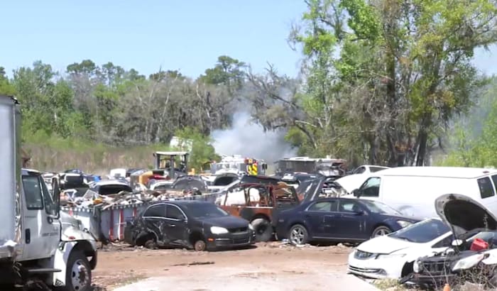 Several vehicles catch fire at used auto parts business on West Beaver Street