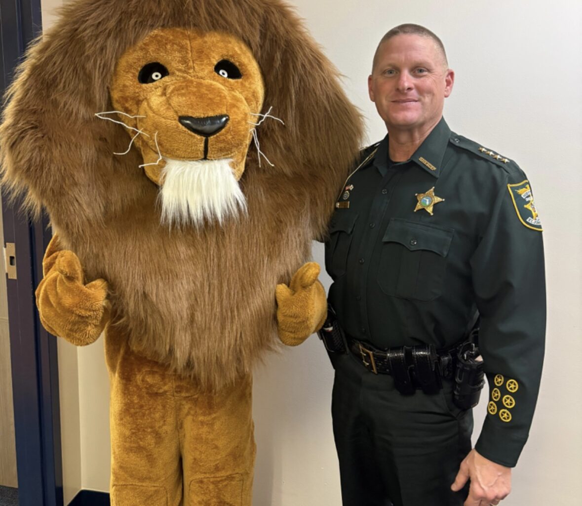 The Landrum Middle School mascot joins St. Johns County Sheriff Hardwick during the inaugural Lion Fest, which featured a safety talk and community pep rally. Photo courtesy Landrum Middle School PTO