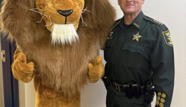The Landrum Middle School mascot joins St. Johns County Sheriff Hardwick during the inaugural Lion Fest, which featured a safety talk and community pep rally. Photo courtesy Landrum Middle School PTO