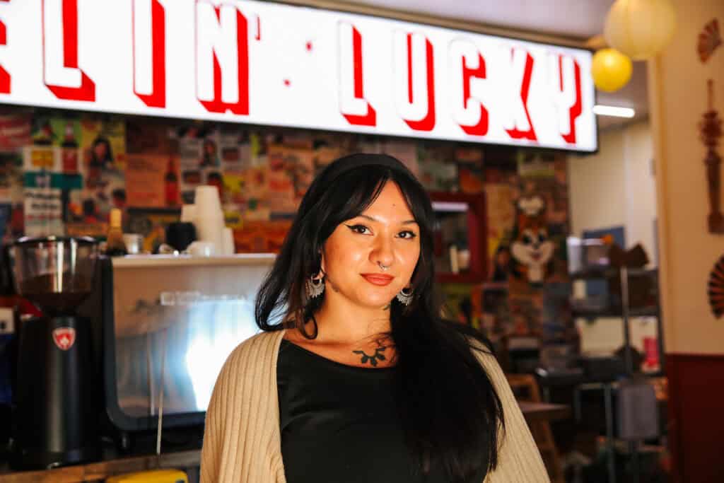 A chef standing at a shop