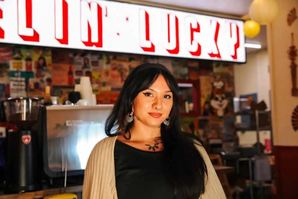 A chef standing at a shop