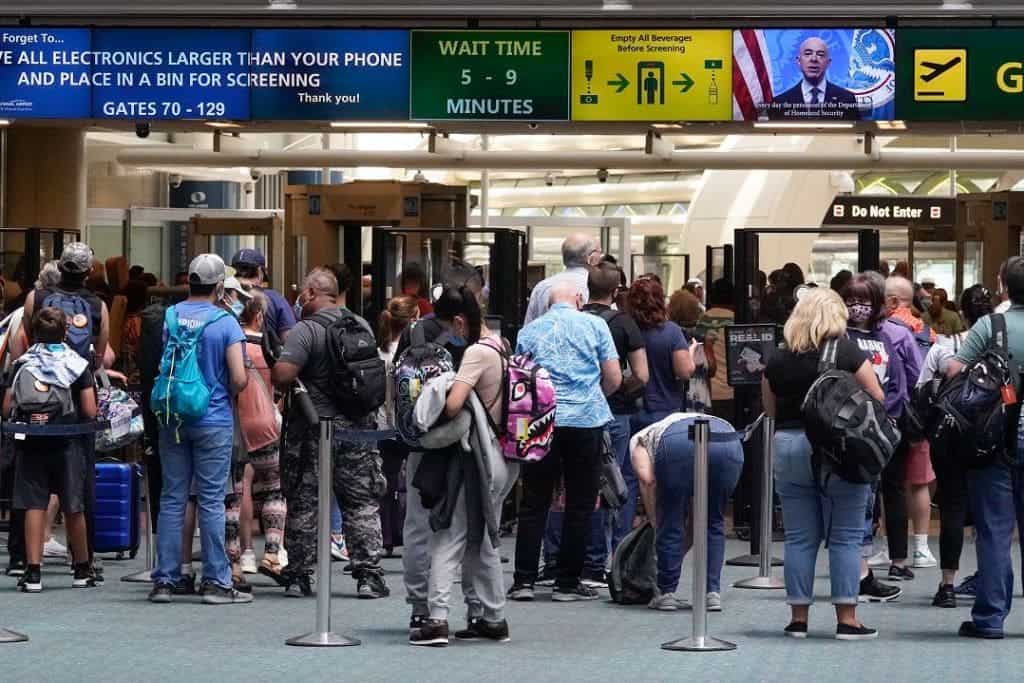 Large crowds inside of a terminal at Orlando International Airport.