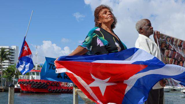 Olga Gomez feels a cool breeze as she and her husband, Feliz Cifuentes, right, participate with Movimiento Democracia, along with the Movement of Opponents for a New Republic (MONR) and several prominent activists, in a press conference. The event addresses the denial of the Right to Return for Cuban exiles to their homeland. It also focuses on the civic response to the upcoming “Our America Convoy,” which is being organized by Mariela Castro and groups affiliated with the Cuban regime. 