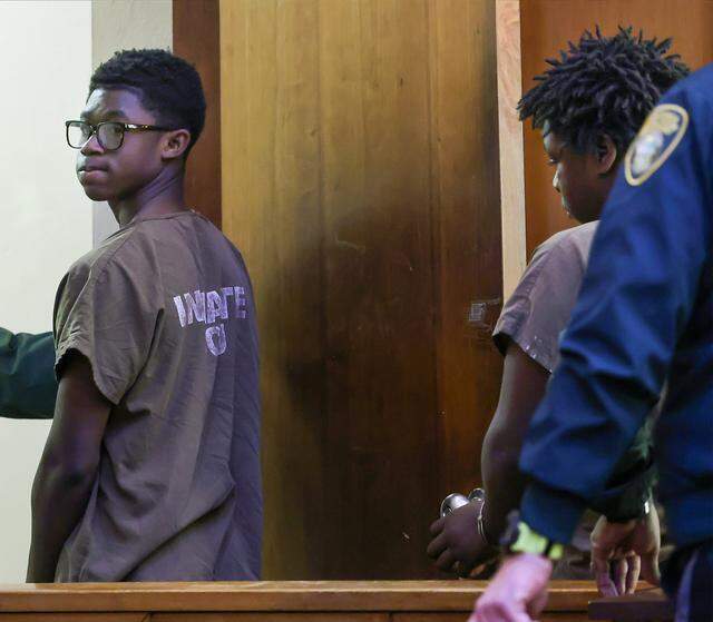 Nelson Nunez, left, looks back as he and Jusiah Jones, right, exit the courtroom after being charged as adults in the rape of a 12-year-old girl, and appeared in Judge Richard Hirsch's Courtroom 4-8 for their bond hearing on Wednesday, March 18, 2026, at the Richard E. Gershwin Justice Building in Miami, Florida.