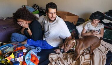 Michael Torres, center, and wife Diana Olivo, left, Maylynda, right, and her two brothers, not pictured, have been sharing a motel room for the last six months with their pets. He does not know how long they'll be able to afford to stay there, and he reflects on the challenges of being unsheltered on Wednesday, February 25, 2026, in Miami-Dade, Florida.