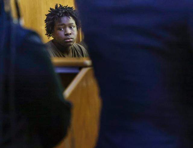 Jusiah Jones, center, looks at his family members as he is present in Judge Richard Hirsch's courtroom 4-8 for his bond hearing. He is one of the three boys charged as adults in the rape of a 12-year-old girl. This hearing took place on Wednesday, March 18, 2026, at the Richard E. Gershwin Justice Building in Miami, Florida.