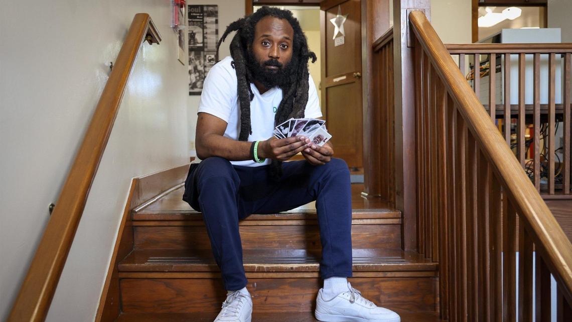 Sitting inside the Old Dillard Museum, Emmanuel George holds a deck of Black Broward flashcards that he is launching to celebrate and educate about the county’s rich Black history.