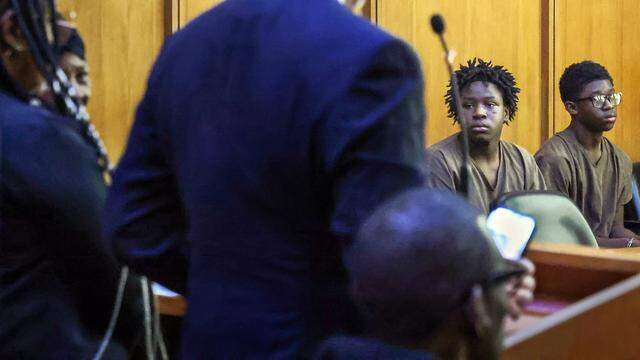 Jusiah Jones, center, looks at his family members while he and Xavier Tyson, right, are present in Judge Richard Hirsch's courtroom 4-8 for their bond hearing. They are two of the three boys charged as adults in the rape of a 12-year-old girl. This hearing took place on Wednesday, March 18, 2026, at the Richard E. Gershwin Justice Building in Miami, Florida.