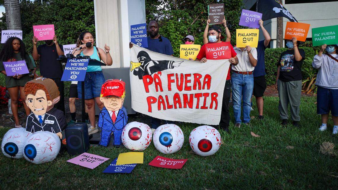 Organizer Cathy Carrillo stands at the makeshift podium to give her remarks as a small group of gathered around the mall entrance, wielding bright signs that conveyed messages calling for increased accountability and transparency from the tech giant on Tuesday, March 3, 2026 at the entrance of Aventura Mall in Aventura, Florida.