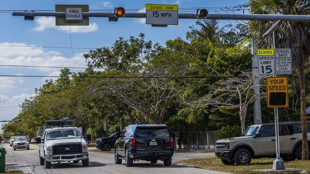 Cars drives by some school-zone speed limit signals that are part of the “School Zone Camera Safety Program” installed around the Palmetto Elementary, located at 12401 SW 74th Ave Pinecrest, on Wednesday, February 25, 2026.