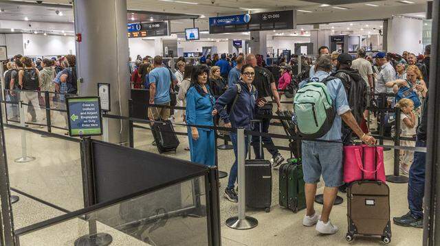 Passenger traffic moves at what a supervisor described as a normal pace at Checkpoint 3 at Miami International Airport on Friday, March 20, 2026, as a partial government shutdown causes TSA worker shortages and leads to long security lines nationwide.