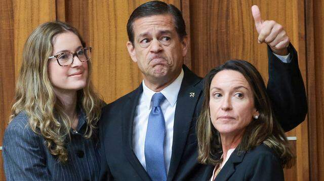 Flanked by his daughter, Carolina Pino, left, and wife, Cecilia Pino, right, real estate broker George Pino acknowledges supporters as they arrive in Courtroom 4-1 for his surrender at the Richard E. Gerstein Justice Building on Thursday, November 21, 2024, in Miami, Florida. 