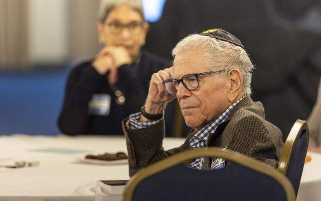 Stewart Merkin listens to speakers during an iftar dinner welcoming Muslims and Jews to discuss the role of fasting in both traditions at Temple Israel of Greater Miami on Friday, Feb. 27, 2026, in Miami, Fla.