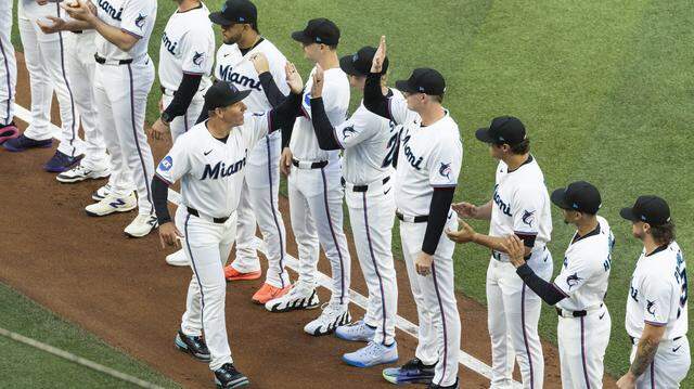 Miami Marlins manager Clayton McCullough (86) greets his teammates during the opening ceremonies of their MLB game against the Colorado Rockies at loanDepot park on Friday, March 27, 2026, in Miami, Fla.