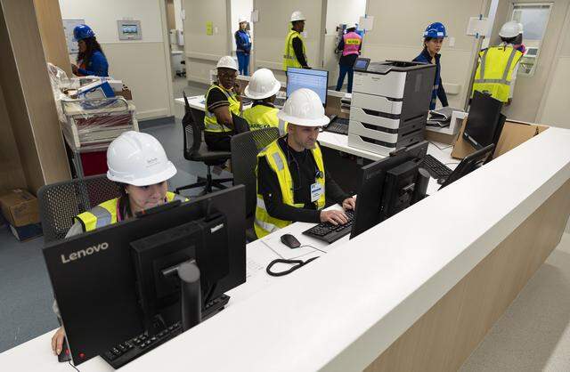 Jackson Memorial Hospital nurse practitioner Eli Bryski, center, uses a computer at a nurses' station during a tour of the hospital's new emergency department on Thursday, March 5, 2026, in Miami, Fla. The new facility doubles the size of the current emergency room and is expected to reduce patient wait times.
