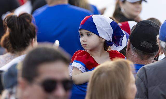 A girl looks on as she attends the Free Cuba Rally at Milander Park on Tuesday, March 24, 2026, in Hialeah, Fla. The demonstration, which was organized in part by the City of Hialeah, aims to bring together voices of the Cuban exile community in support of Cuba's freedom.