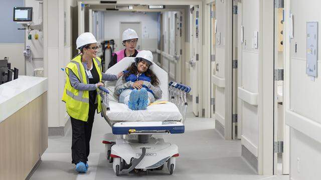From left to right: Jackson Memorial Hospital registered nurse Anicia Dominguez, nurse practitioner Arliette Vita and Miami Dade College student Ashley Rivera perform a simulation of a patient's experience as they make their way into a resuscitation area during a tour of the hospital's new emergency department on Thursday, March 5, 2026, in Miami, Fla. The new facility doubles the size of the current emergency room and is expected to reduce patient wait times.