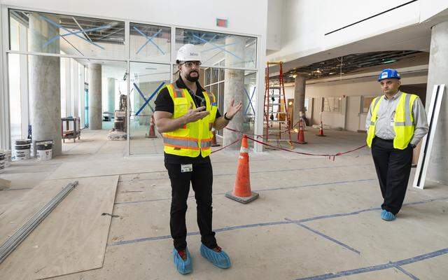 Jackson Memorial Hospital Director of Facilities Design and Construction Jorge Luis Garcia, left, gives a tour of the hospital's new emergency department lobby on Thursday, March 5, 2026, in Miami, Fla. The new facility doubles the size of the current emergency room and is expected to reduce patient wait times.